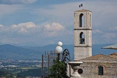 Italian flag on bell tower against sky