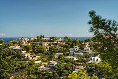 High angle view of townscape against clear blue sky