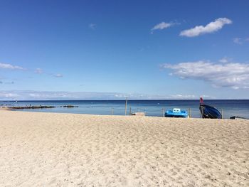 Scenic view of beach against blue sky