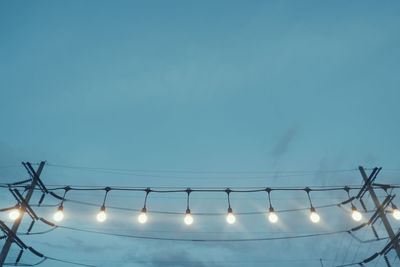 Low angle view of electricity pylon against clear sky