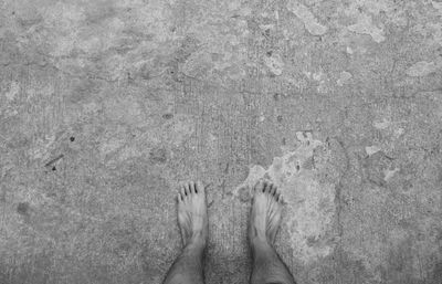 Low section of people standing on tiled floor