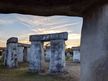 Old ruin on field against sky during sunset