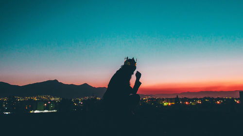 Silhouette man against sky during sunset