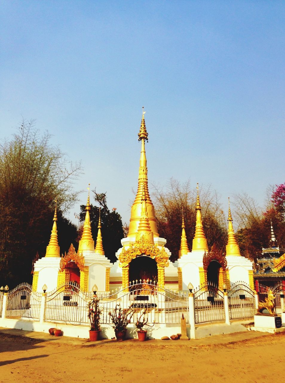 clear sky, copy space, blue, religion, place of worship, building exterior, built structure, architecture, spirituality, tourism, travel destinations, tree, travel, incidental people, famous place, outdoors, dome, temple - building