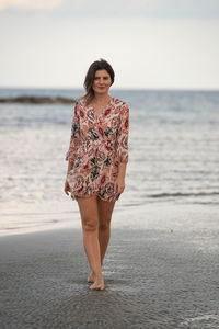 Young woman standing at beach