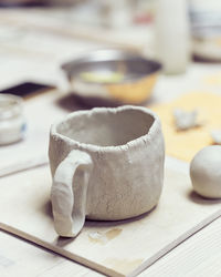 Close-up of clay cup on table