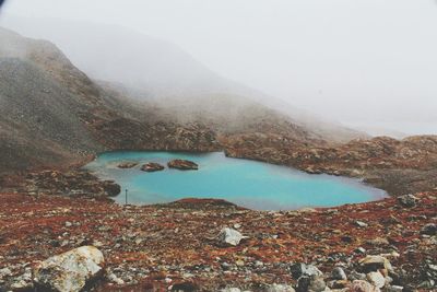 High angle view of lake surrounded by mountains