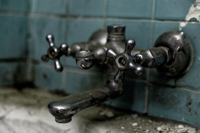 Close-up of faucet in abandoned bathroom