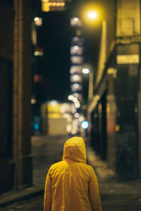 Rear view of woman standing in city