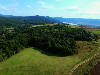 Scenic view of green landscape against sky