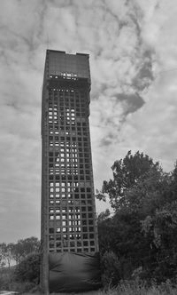 Low angle view of building against cloudy sky