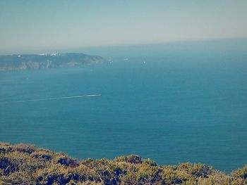 Scenic view of sea against clear blue sky