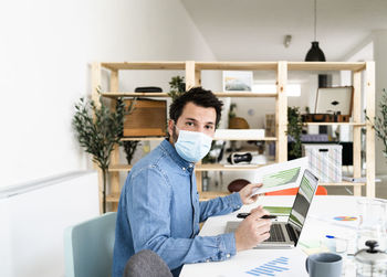 Portrait of man working on table