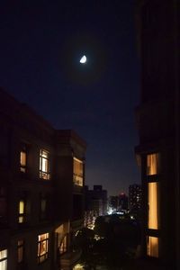 Illuminated buildings against sky at night