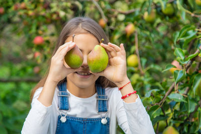 Midsection of woman holding fruit