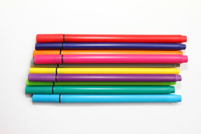 Close-up of colored pencils over white background