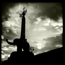 Low angle view of statue against cloudy sky