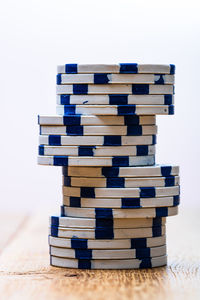 Close-up of stack of table against white background