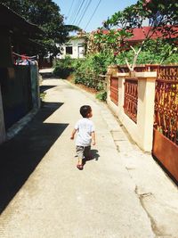 Rear view of boy on footpath