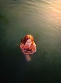 Reflection of young woman in water