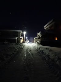 Snow covered road at night