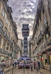 People on street amidst buildings in city