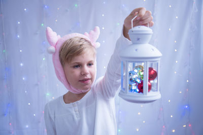 Close-up of girl holding lantern