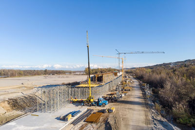 Panoramic shot of construction site against clear blue sky