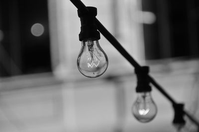 Close-up of light bulb hanging on cable