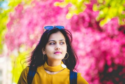 Portrait of beautiful young woman looking away