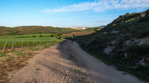 Dirt road along countryside landscape