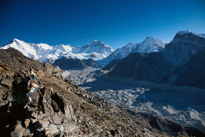 Scenic view of snowcapped mountains against clear blue sky