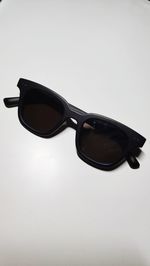 Close-up of sunglasses against white background