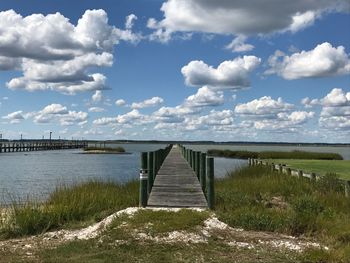 Pier over lake against sky