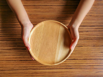 High angle view of woman hand on table