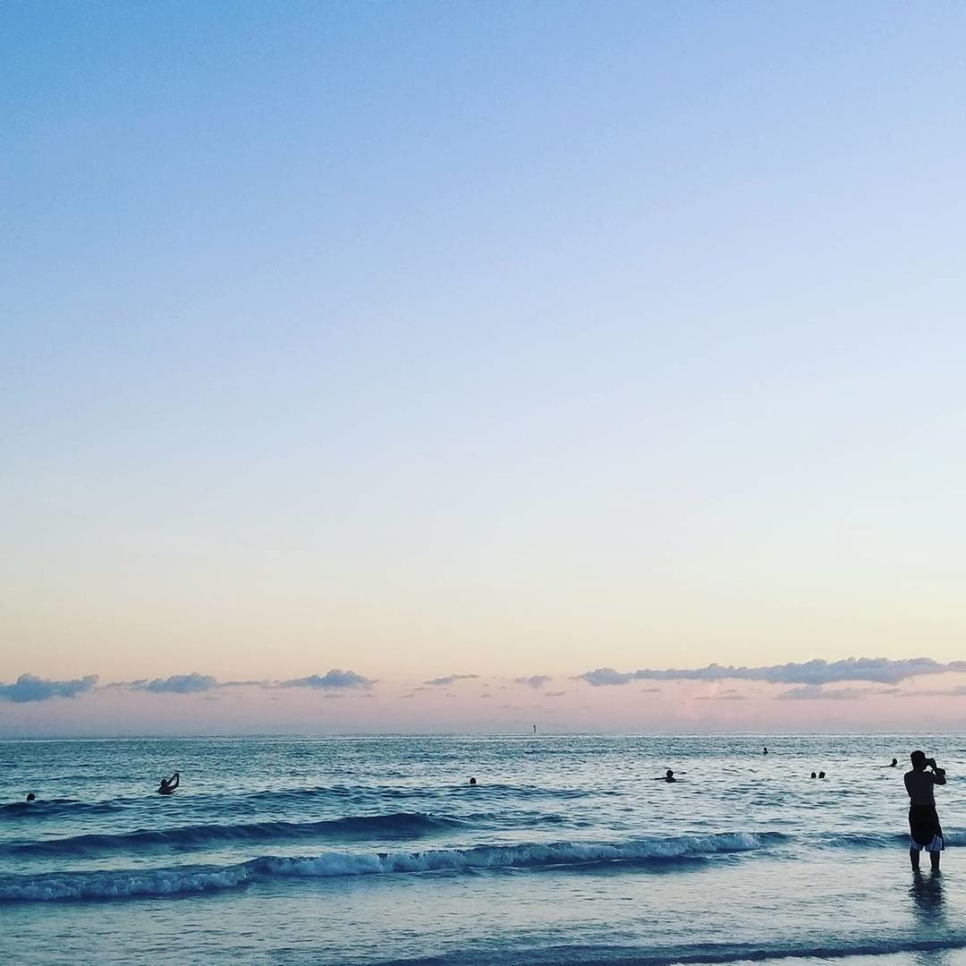 SILHOUETTE MAN STANDING ON BEACH AGAINST SKY DURING SUNSET