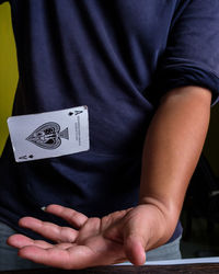 Midsection of man playing poker