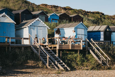 Houses on beach by buildings