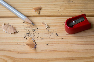 Pencil with shavings and sharpener on table