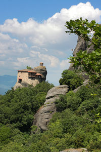 Castle on mountain against sky