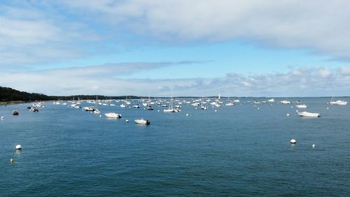 Sailboats in sea against sky