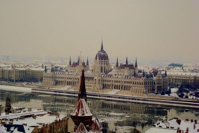 High angle view of city lit up at riverbank