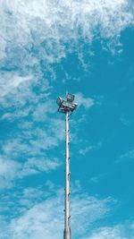 Low angle view of floodlight against blue sky