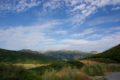 Scenic view of landscape and mountains against sky