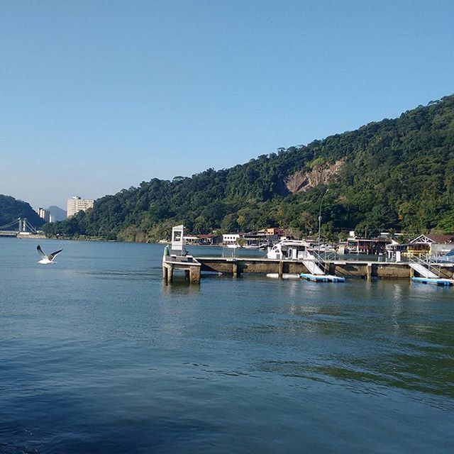 nautical vessel, water, boat, transportation, mountain, mode of transport, clear sky, moored, waterfront, sea, tranquil scene, tranquility, tree, scenics, copy space, nature, beauty in nature, lake, blue, mountain range