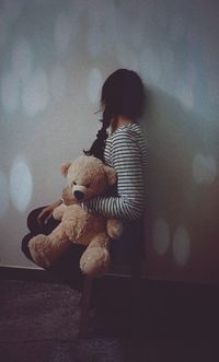 Close-up of girl looking at toy