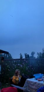 Couple relaxing against blue sky