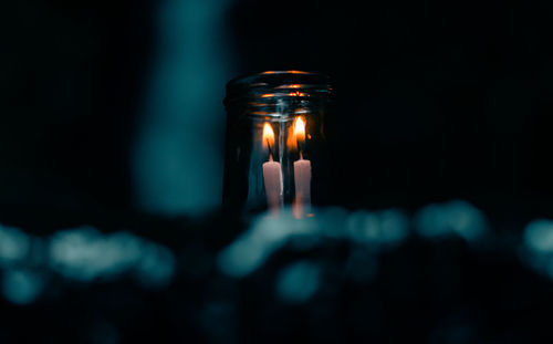 Close-up of illuminated lamp in dark room