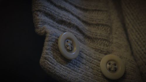 Close-up of buttons on sweater