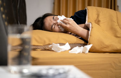 Portrait of woman sleeping on bed